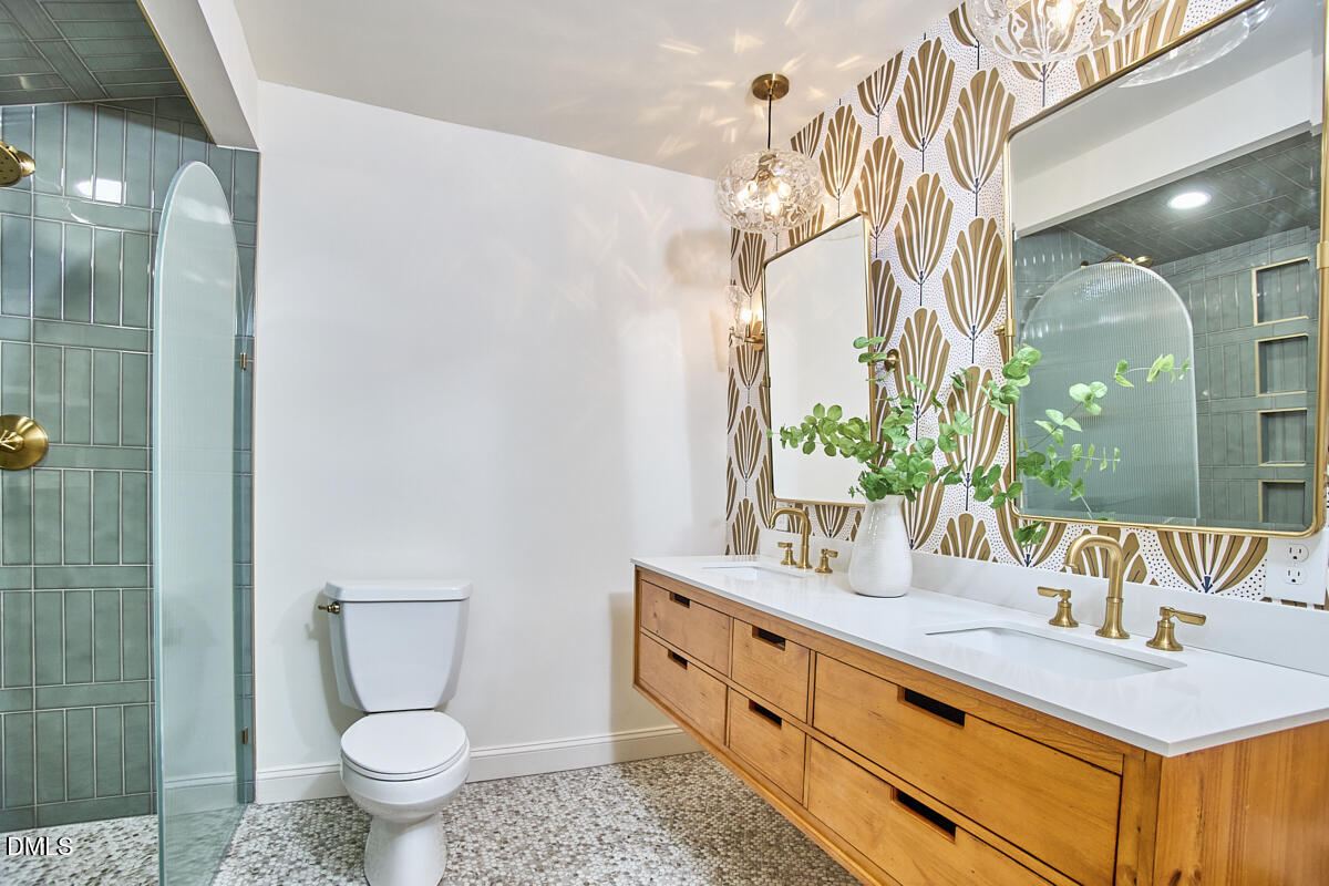 1609 Acadia Street Durham, NC 27701 - Photo 38 of 56 a bathroom with a granite countertop sink mirror vanity and toilet