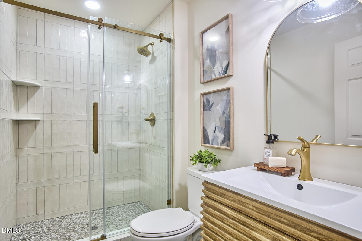 1609 Acadia Street Durham, NC 27701 - Photo 46 of 56 a bathroom with a sink toilet and shower