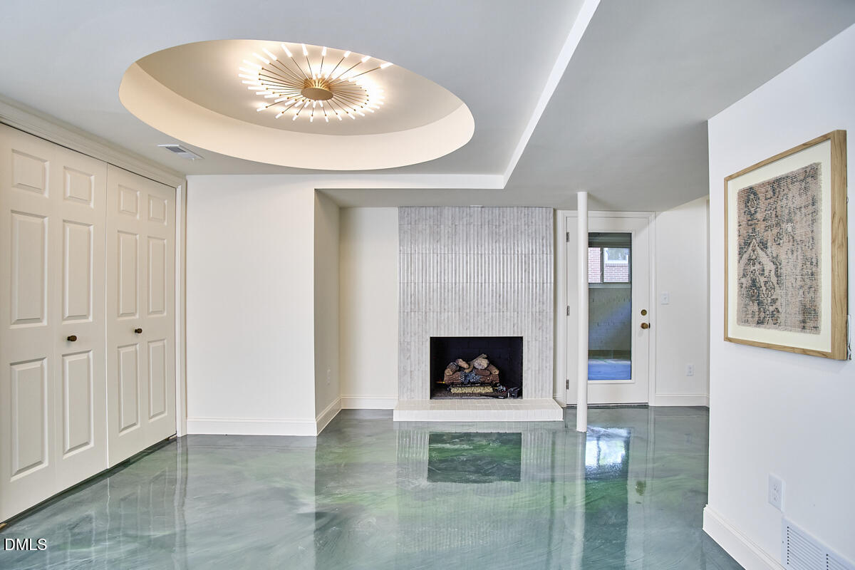 1609 Acadia Street Durham, NC 27701 - Photo 47 of 56 a view of an empty room with a fireplace and a window
