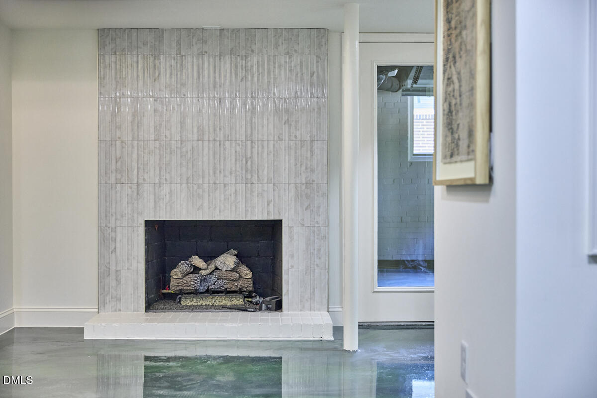 1609 Acadia Street Durham, NC 27701 - Photo 49 of 56 a living room with a fireplace and a rug