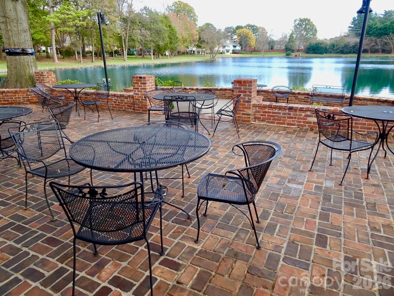 7027 Quail Hill Road Charlotte, NC 28210 - Photo 3 of 6 a view of a lake with table and chairs