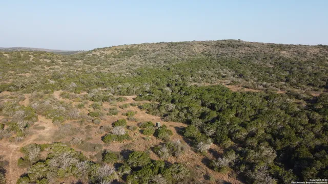a view of a large building with mountains in the background