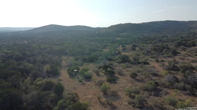 a view of a mountain range with trees in the background