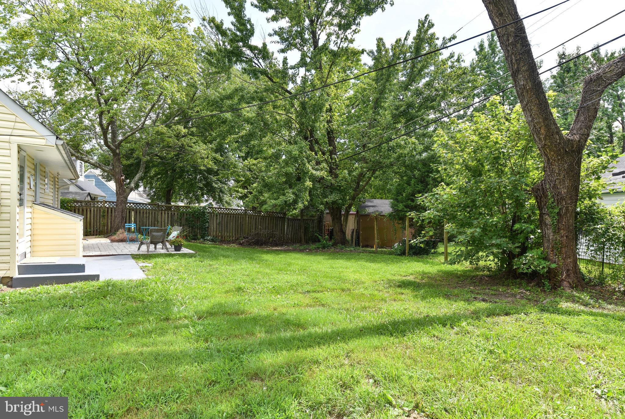 7002 Quander Road Alexandria, VA 22307 - Photo 19 of 23 a backyard of a house with table and chairs