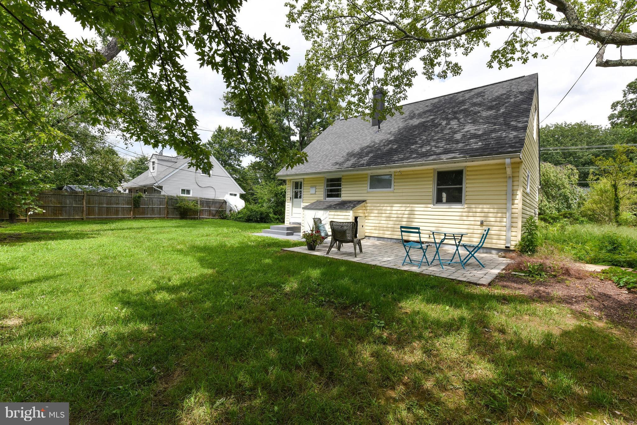 7002 Quander Road Alexandria, VA 22307 - Photo 21 of 23 a backyard of a house with table and chairs