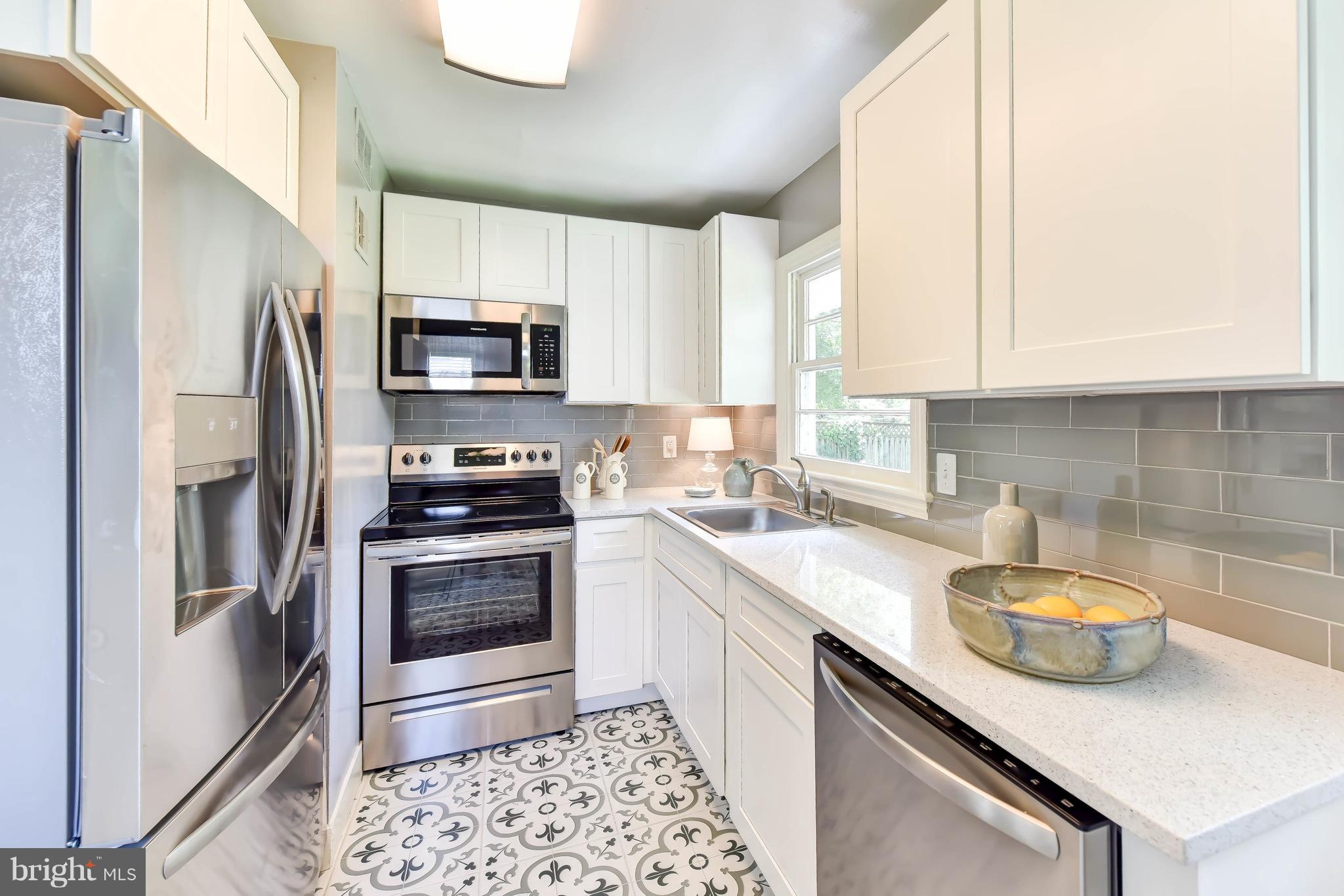 7002 Quander Road Alexandria, VA 22307 - Photo 8 of 23 a kitchen with a sink appliances and cabinets
