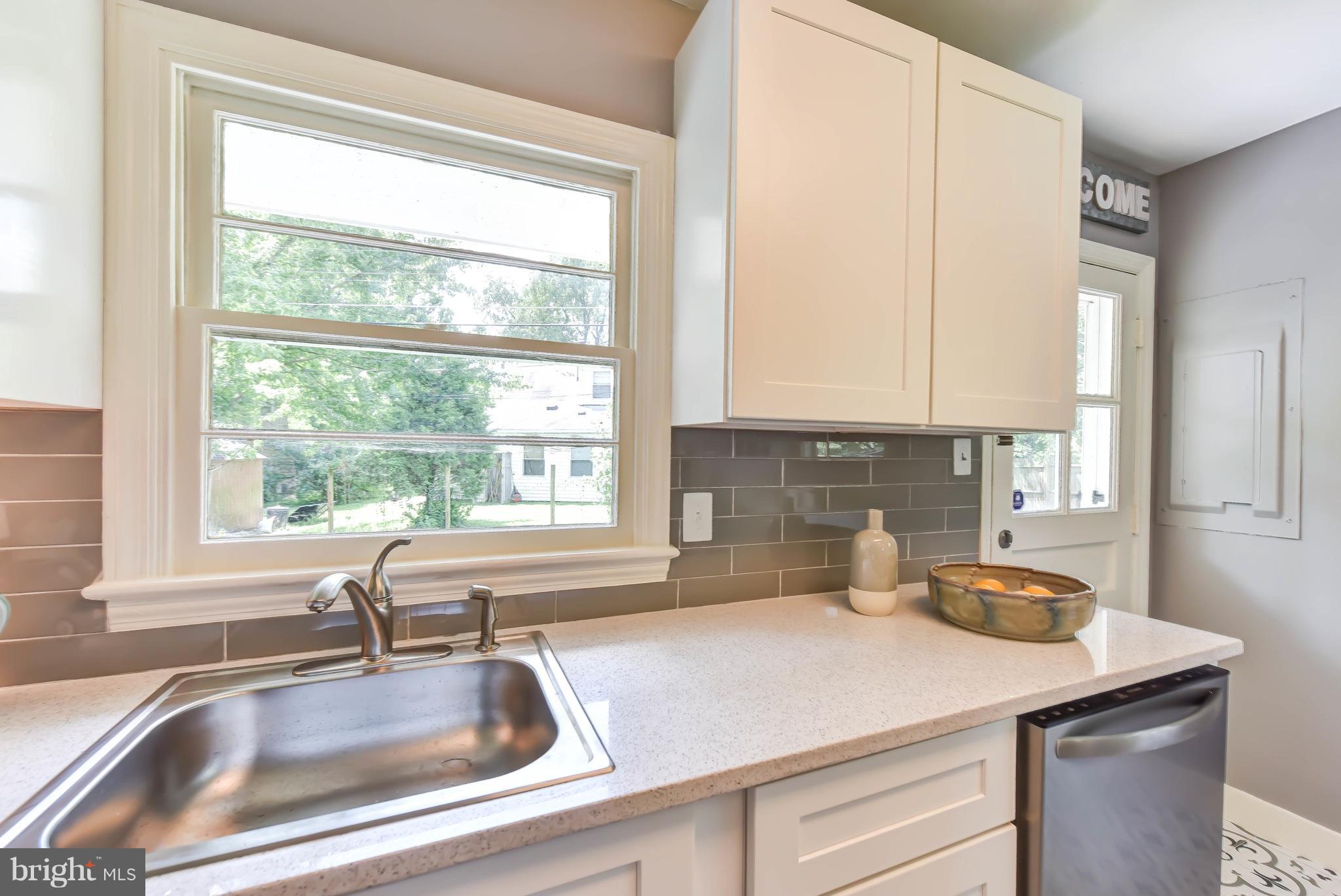 7002 Quander Road Alexandria, VA 22307 - Photo 9 of 23 a kitchen with sink a window and cabinets