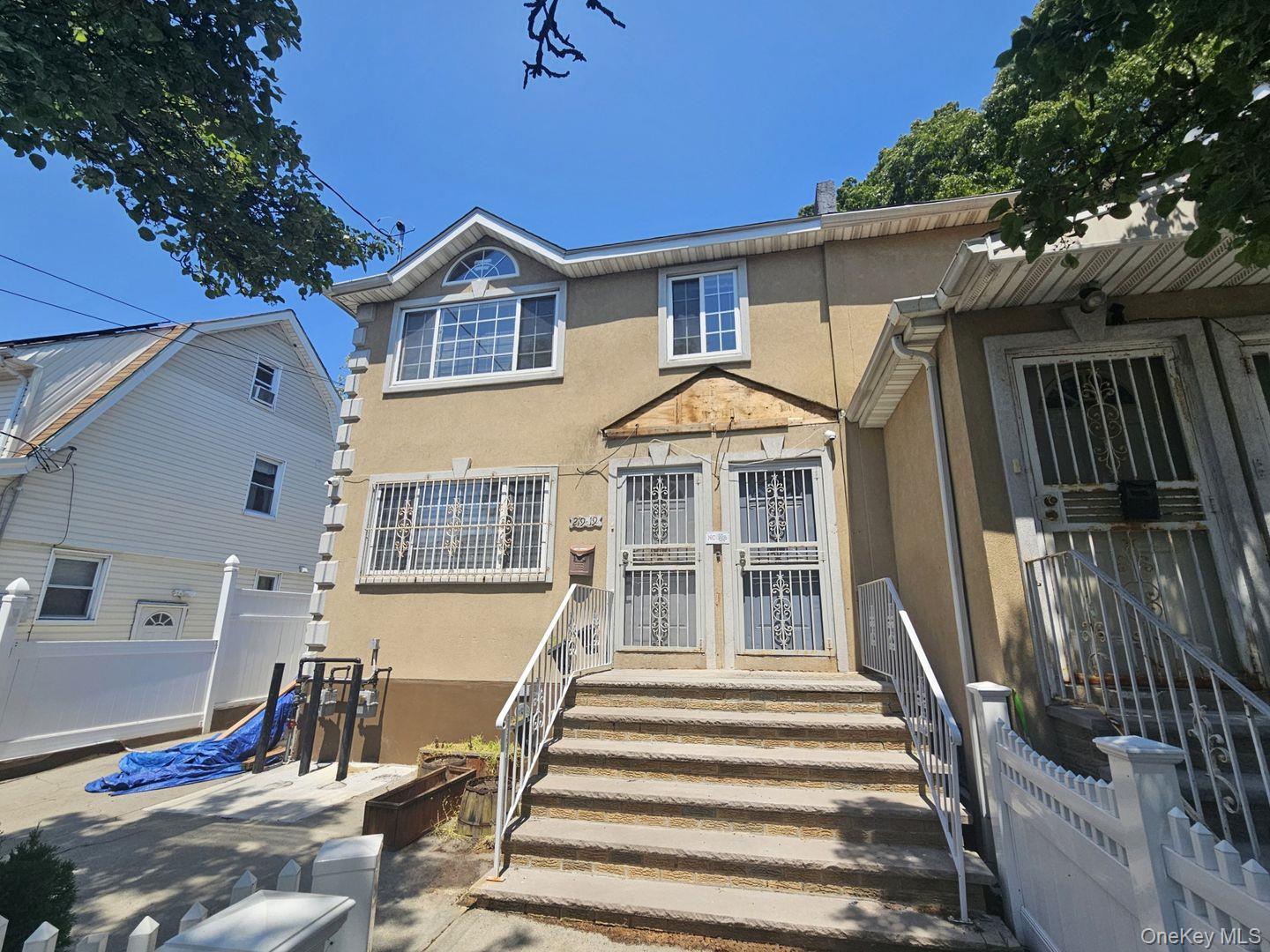 219-19 143rd Road Queens, NY 11413 - Photo 2 of 4 a front view of a house