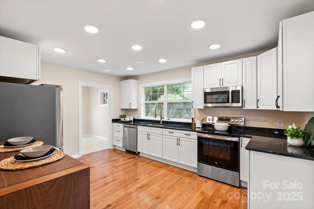 6034 Tuckaseegee Road Charlotte, NC 28208 - Photo 15 of 35 a kitchen with stainless steel appliances granite countertop a sink stove and refrigerator