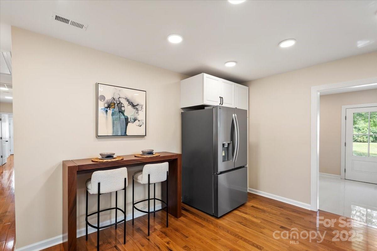 6034 Tuckaseegee Road Charlotte, NC 28208 - Photo 17 of 35 a room with stainless steel appliances wooden floor and a window