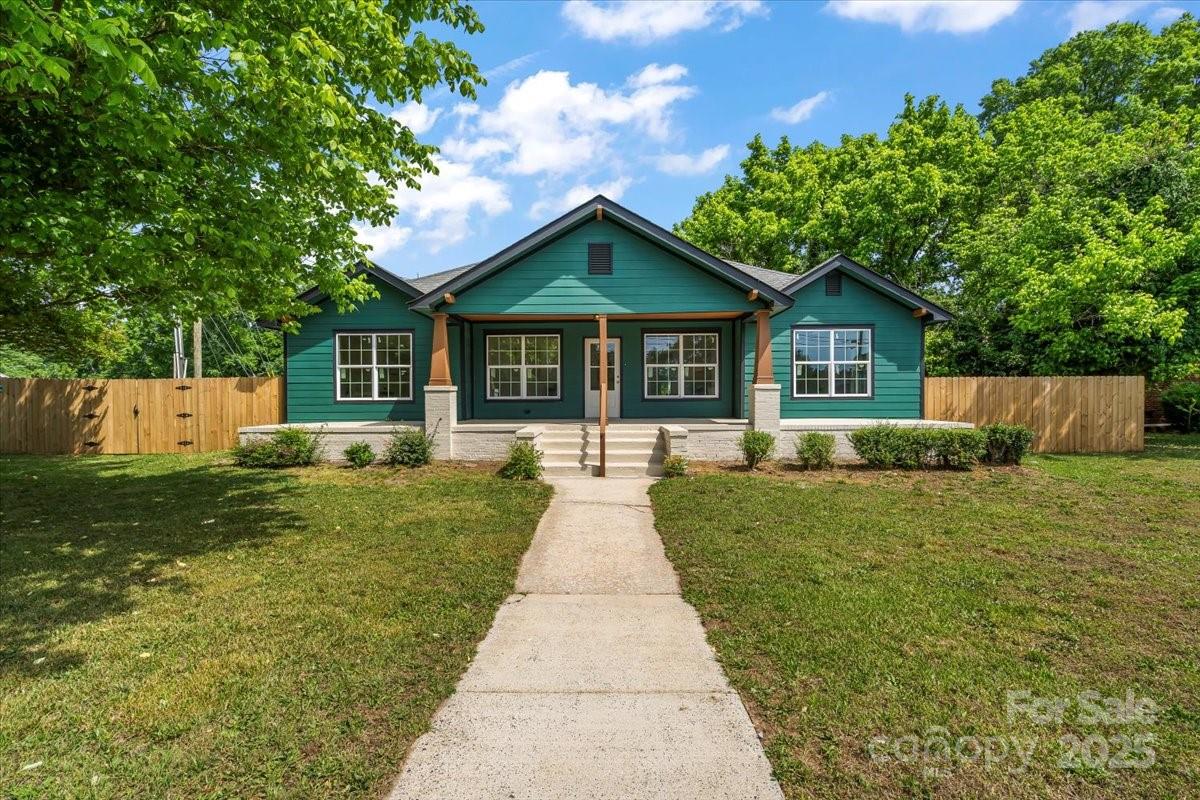 6034 Tuckaseegee Road Charlotte, NC 28208 - Photo 2 of 35 a front view of a house with yard and green space