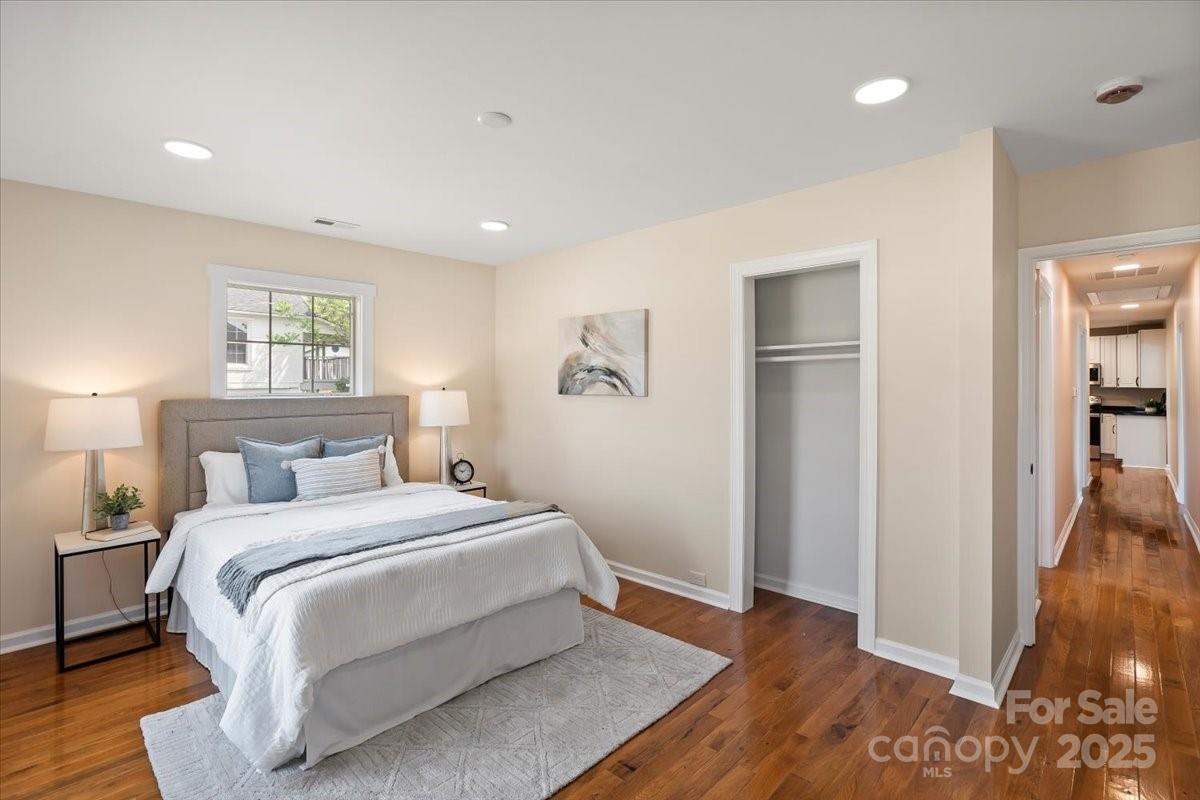 6034 Tuckaseegee Road Charlotte, NC 28208 - Photo 21 of 35 a bedroom with a bed and wooden floor