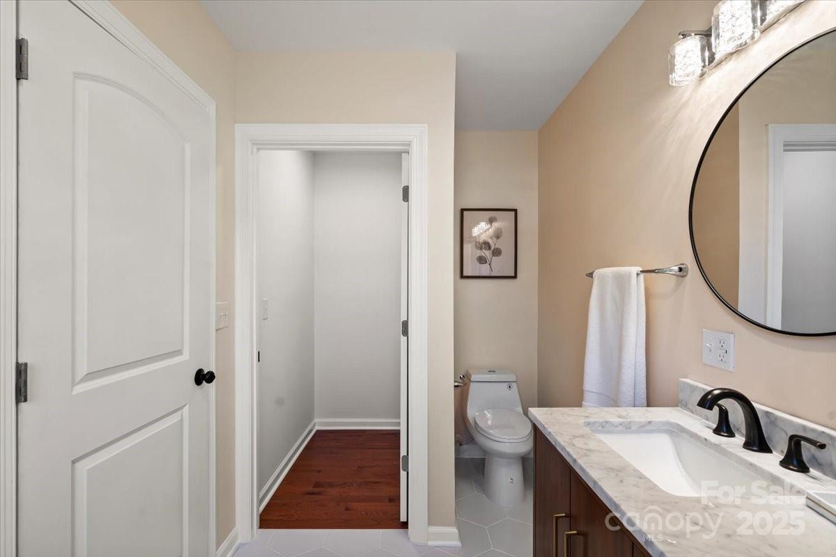 6034 Tuckaseegee Road Charlotte, NC 28208 - Photo 23 of 35 a bathroom with a sink and a mirror