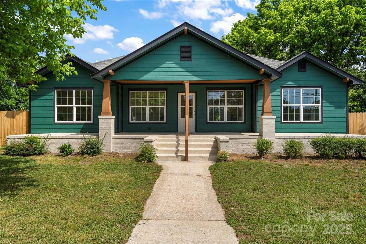 6034 Tuckaseegee Road Charlotte, NC 28208 - Photo 3 of 35 a front view of a house with a yard