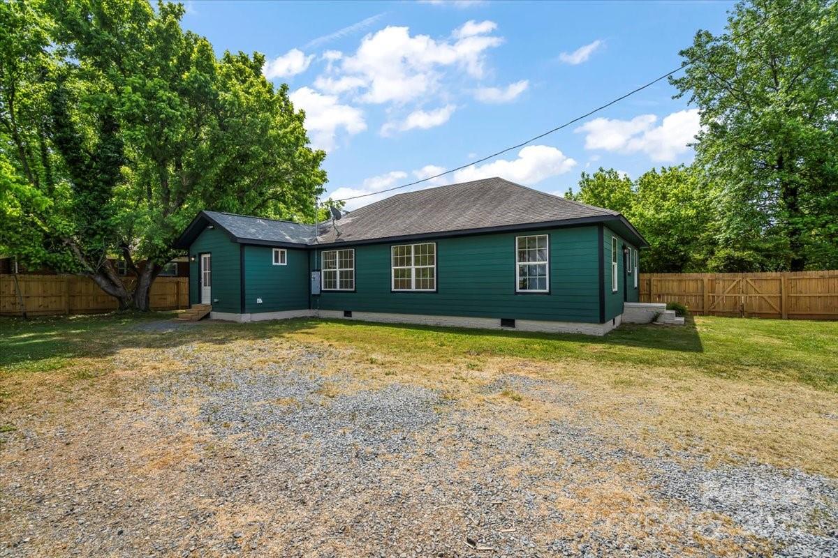 6034 Tuckaseegee Road Charlotte, NC 28208 - Photo 32 of 35 a house with trees in the background