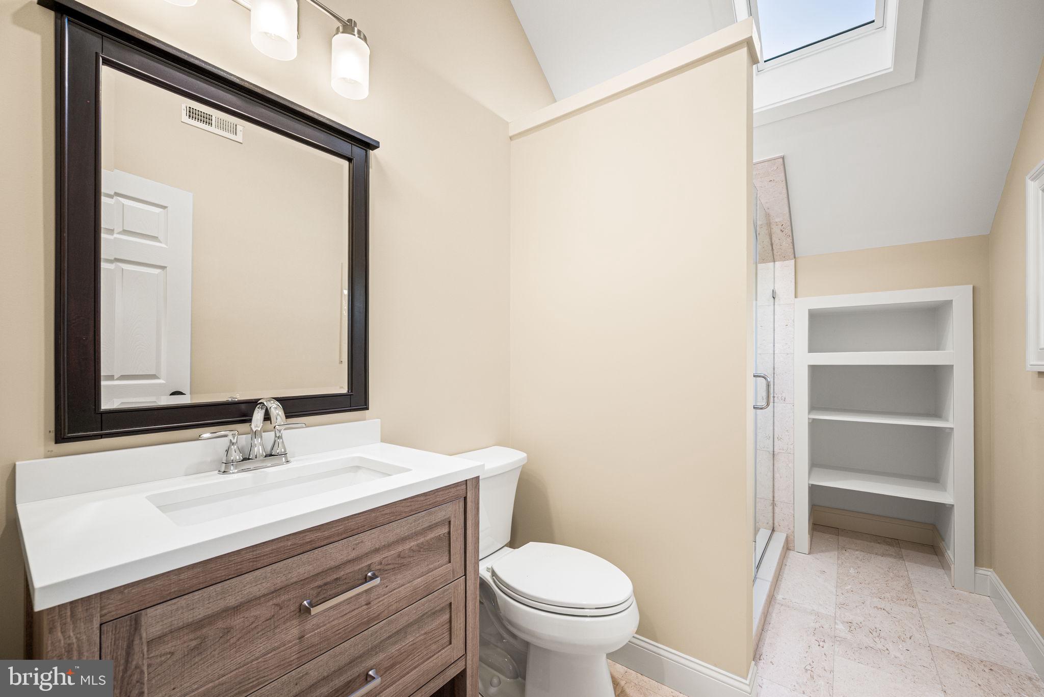 1548 Morstein Road Malvern, PA 19355 - Photo 59 of 80 a bathroom with a sink a toilet and a mirror