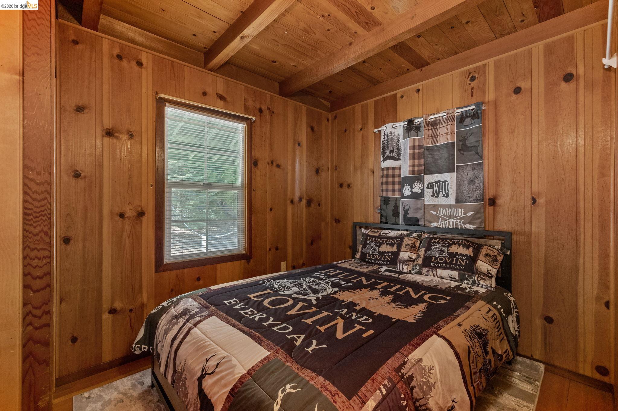 26175 Janice Way Long Barn, CA 95335 - Photo 14 of 23 Bedroom featuring wood walls, wood finished floors, and a wood ceiling with exposed beams