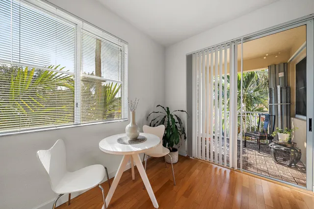 a dining room with furniture and wooden floor