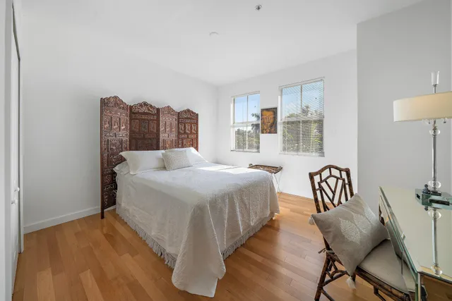 a spacious bedroom with a bed and a chandelier