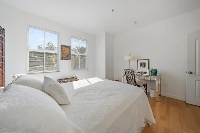 a bedroom with a large bed and a window