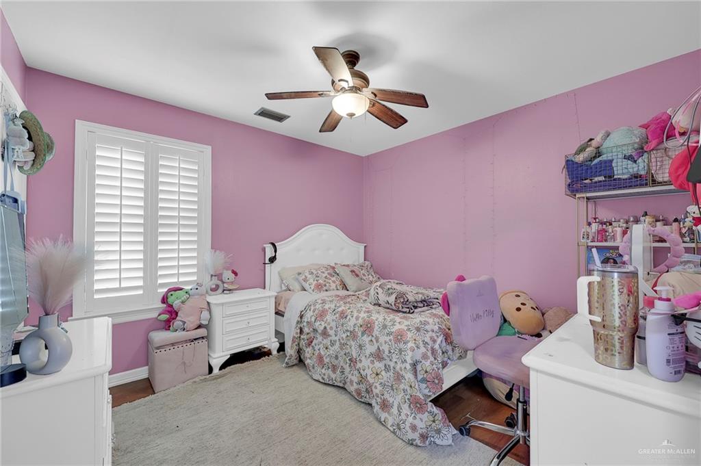12813 North 106th Street Mission, TX 78573 - Photo 11 of 17 Bedroom featuring ceiling fan and wood finished floors