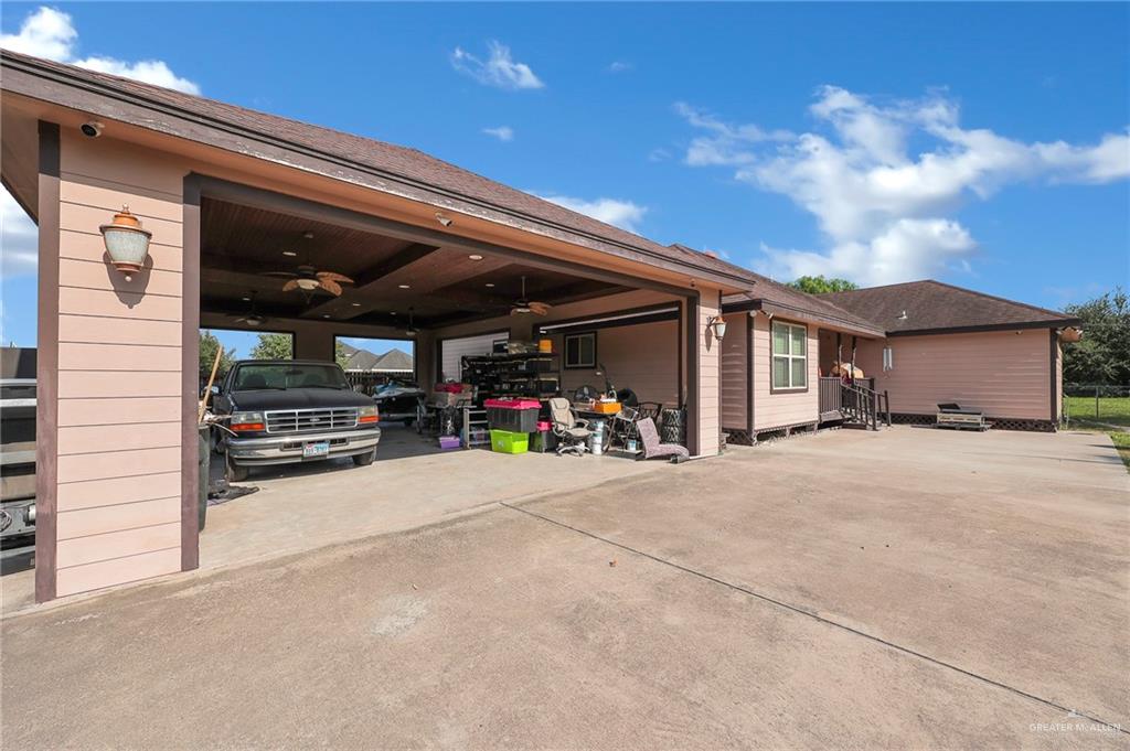 12813 North 106th Street Mission, TX 78573 - Photo 15 of 17 Garage featuring ceiling fan and concrete driveway