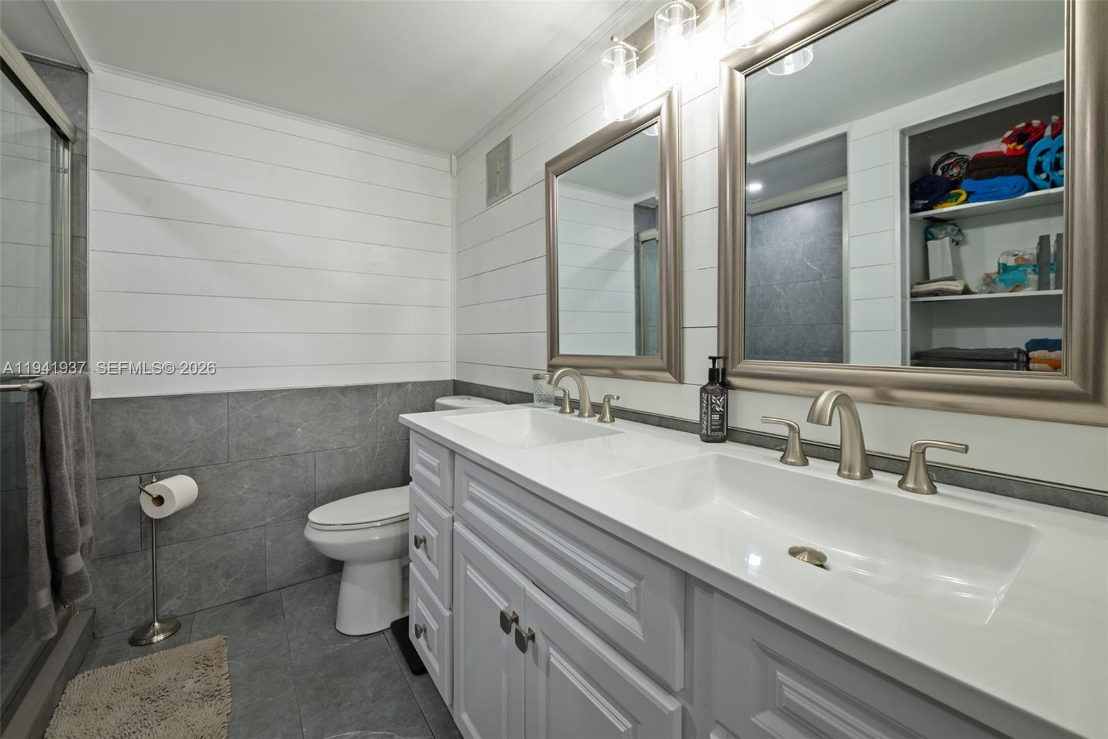 301 Racquet Club Road, Unit 104 Weston, FL 33326 - Photo 9 of 21 a bathroom with a sink and a mirror