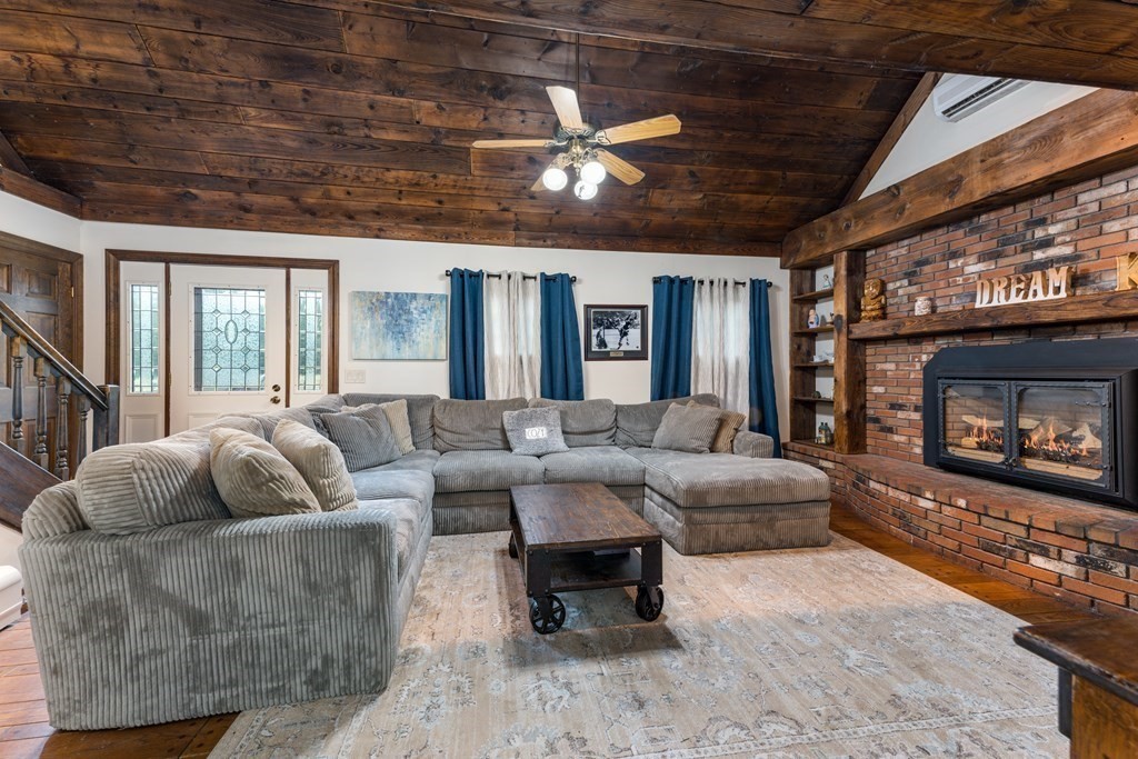 385 Mendell Road Rochester, MA 02770 - Photo 7 of 27 a living room with furniture and a fireplace