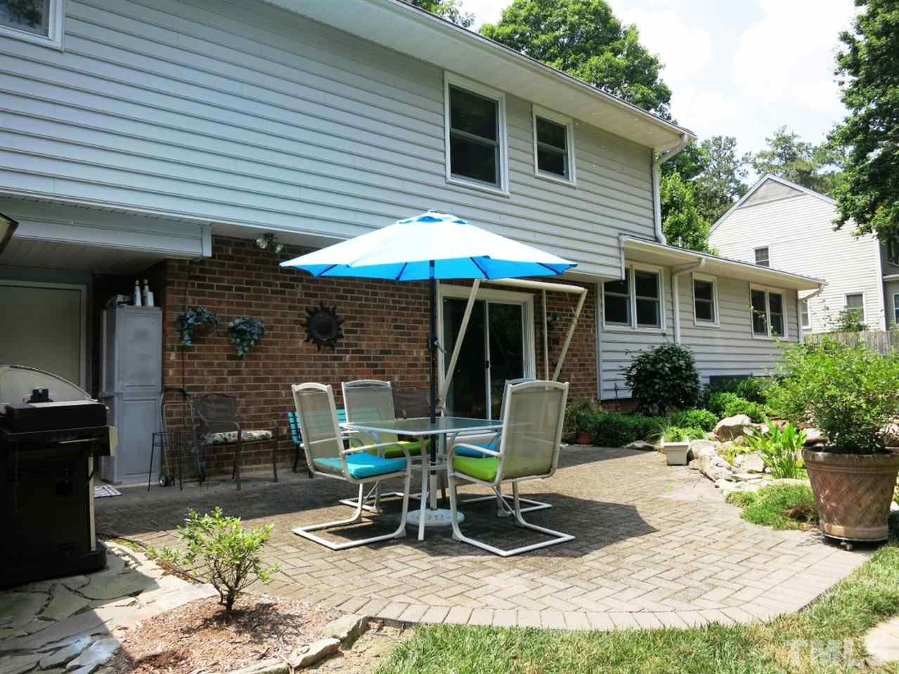 4716 Hiddenbrook Drive Raleigh, NC 27609 - Photo 20 of 25 a view of a chair and table in backyard of the house