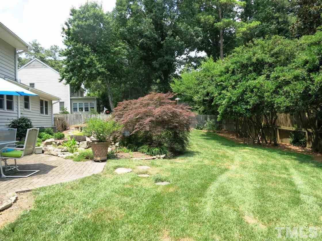 4716 Hiddenbrook Drive Raleigh, NC 27609 - Photo 24 of 25 a view of a backyard with a garden and plants