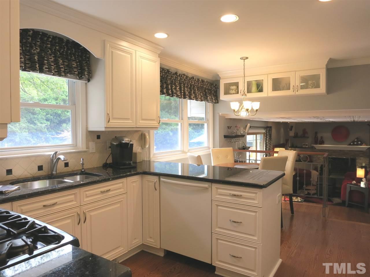 4716 Hiddenbrook Drive Raleigh, NC 27609 - Photo 7 of 25 a kitchen with granite countertop a sink and cabinets