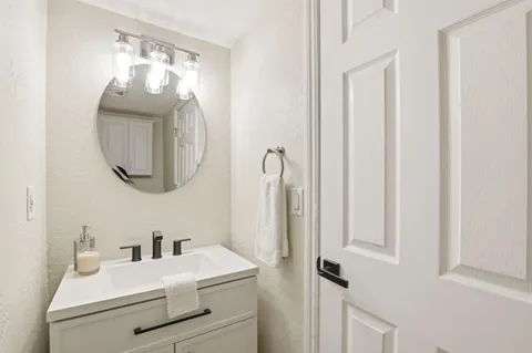 a bathroom with a sink vanity and mirror