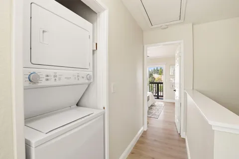 a view of a hallway with washer and dryer