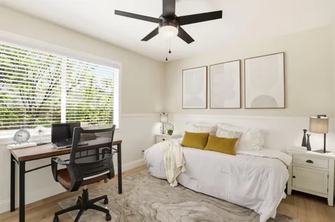 a bedroom with a bed and a table