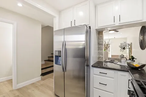 a kitchen with a refrigerator and a sink