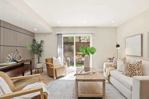 a living room with furniture and a potted plant