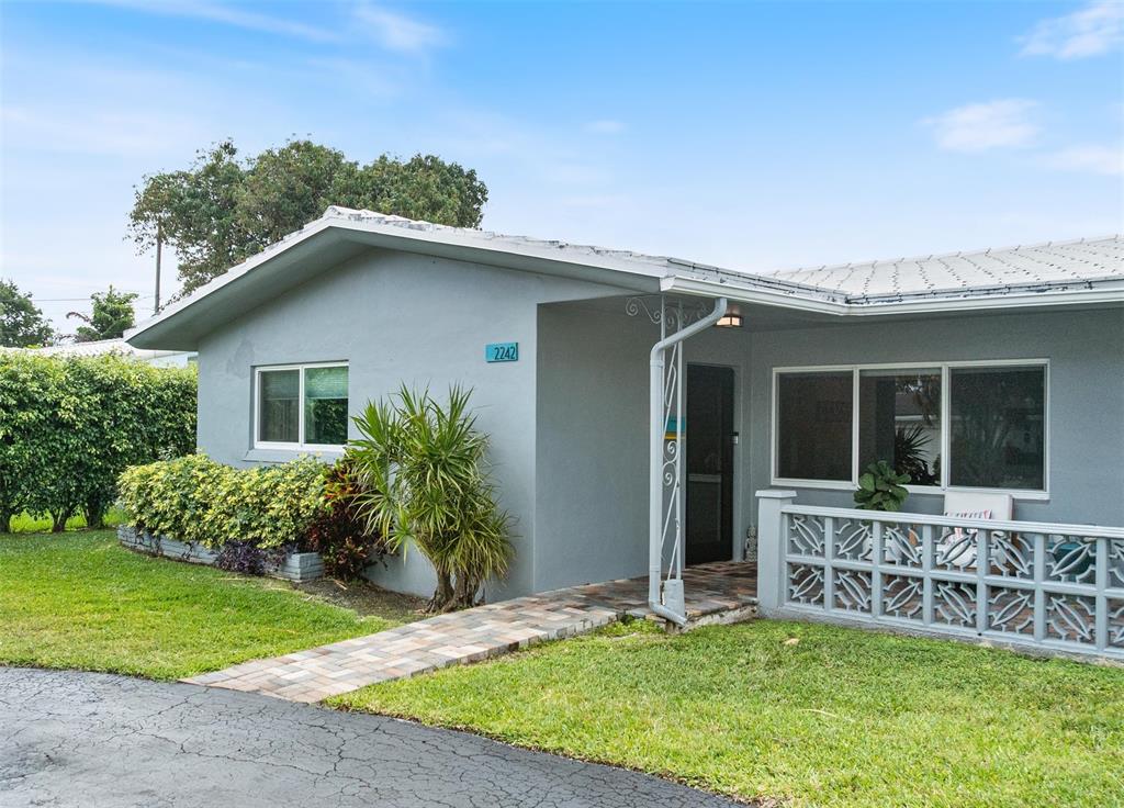 2242 Northeast 37th Street Lighthouse Point, FL 33064 - Photo 1 of 22 a view of house with a yard