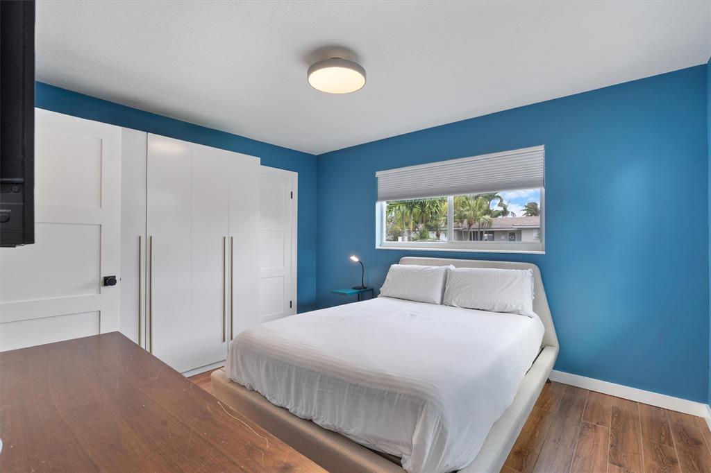 2242 Northeast 37th Street Lighthouse Point, FL 33064 - Photo 17 of 22 a bedroom with a large bed and a window