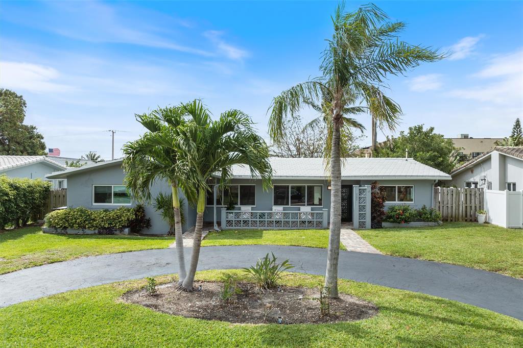 2242 Northeast 37th Street Lighthouse Point, FL 33064 - Photo 21 of 22 a front view of house with yard and green space