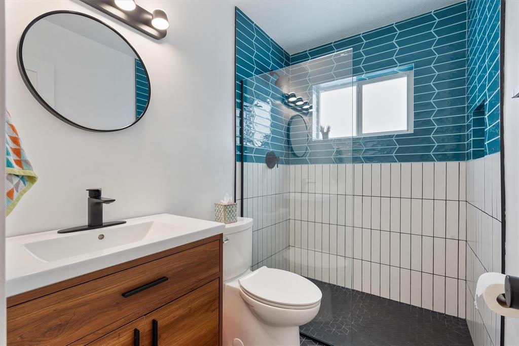 2242 Northeast 37th Street Lighthouse Point, FL 33064 - Photo 9 of 22 a bathroom with a toilet sink vanity and mirror