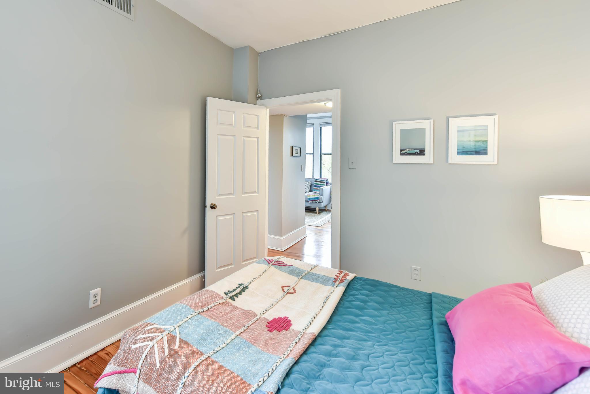 520 E Street Northeast, Unit 401 Washington, DC 20002 - Photo 16 of 23 a bedroom with a bed and wooden floor