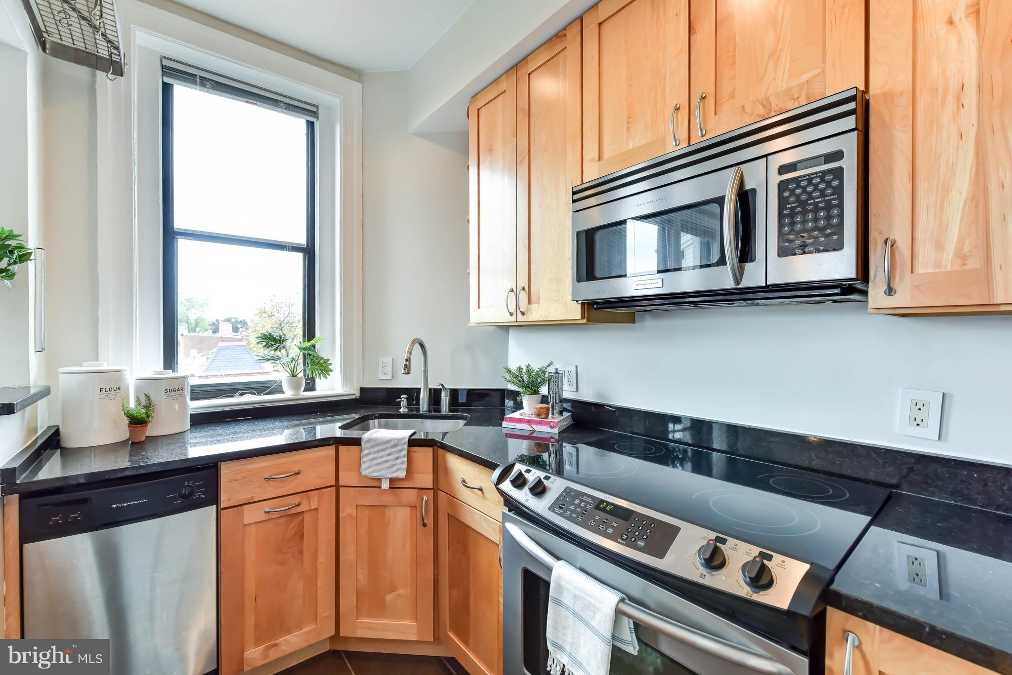 520 E Street Northeast, Unit 401 Washington, DC 20002 - Photo 7 of 23 a kitchen with stainless steel appliances granite countertop a sink stove and cabinets