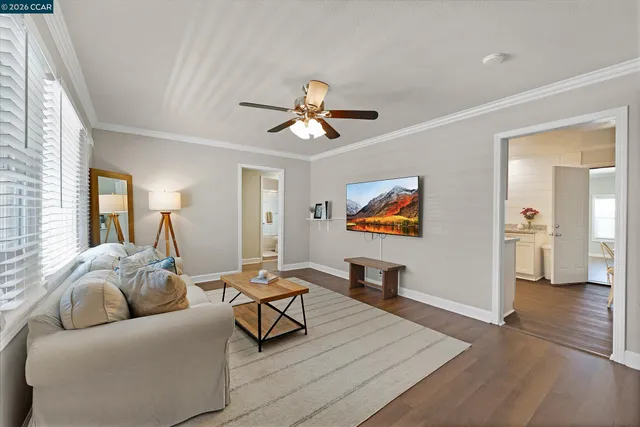 a living room with furniture and a ceiling fan