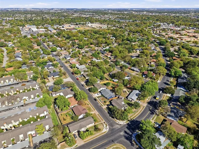 an aerial view of residential houses with outdoor space