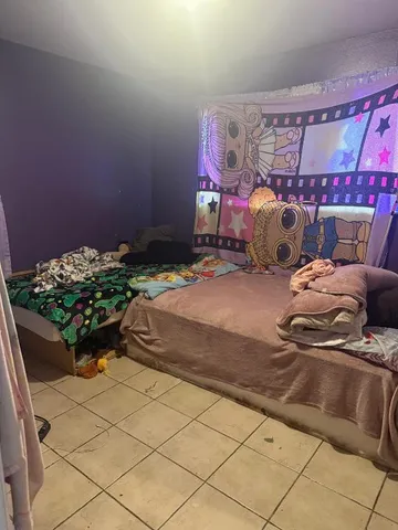 a bedroom with a bed and a baby crib