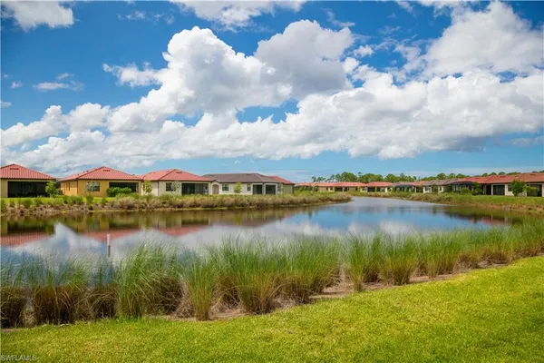 a view of a lake with houses in the back