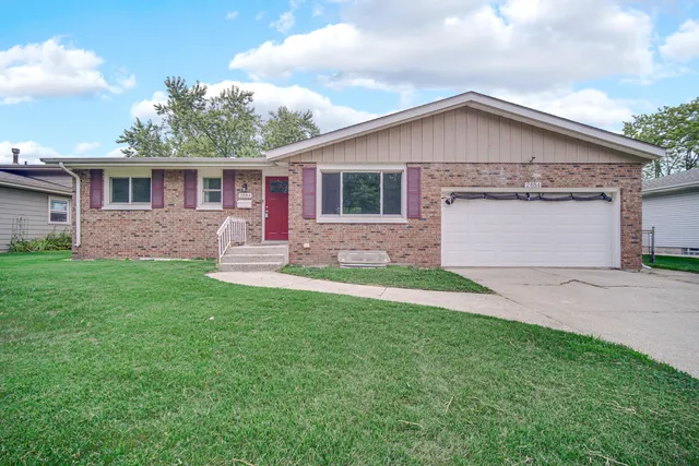 a front view of house with yard and green space