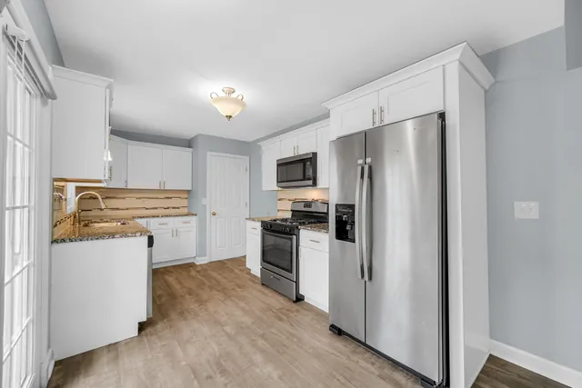 a kitchen with a refrigerator sink and stove