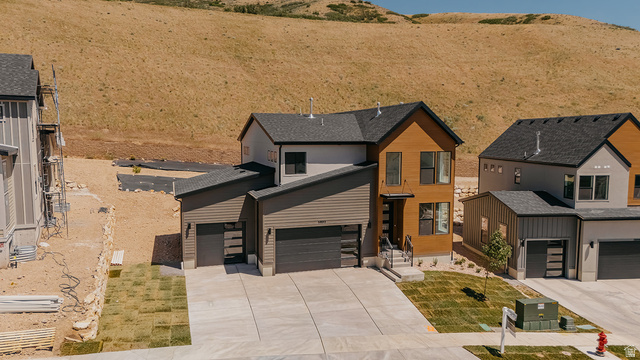 5902 Canyon Rim Road, Unit 620 Lehi, UT 84048 - Photo 77 of 78 Modern two-story residence with a multi-textured exterior, featuring wood-look siding, dark gray horizontal siding, and light gray stucco