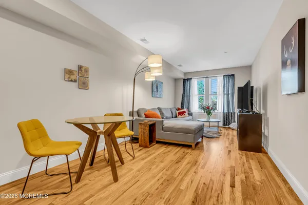 a living room with furniture and a wooden floor